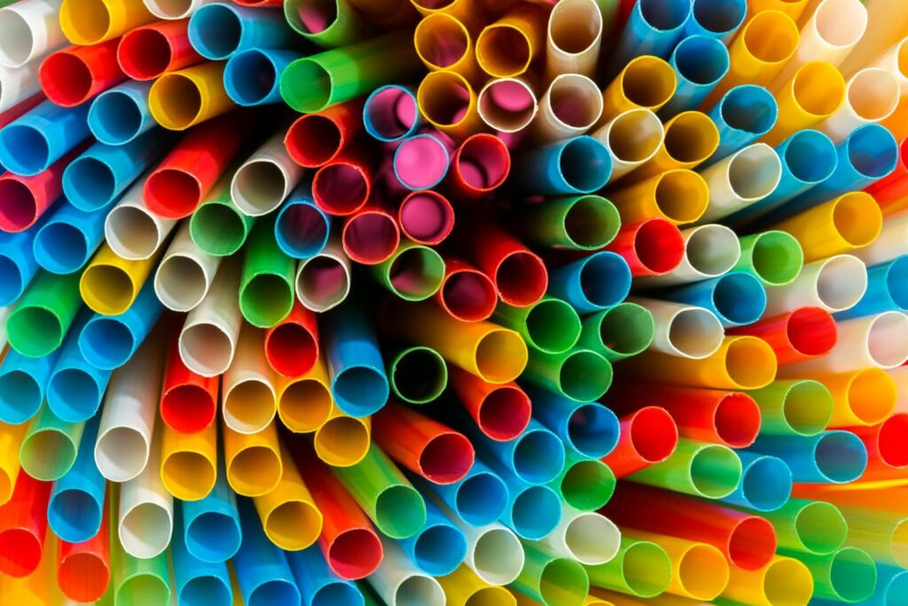 A dynamic assortment of colorful plastic straws arranged in a circular pattern.